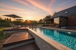 a swimming pool in a backyard with a house at Casa Luna in Ravna Gora