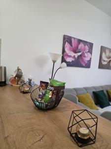 a wooden table with a basket on top of it at Apartman Stars in Podgorica
