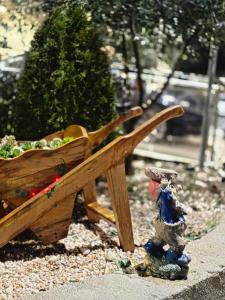 a wooden bench with a figurine standing next to it at Apartman Stars in Podgorica