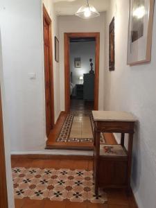 a hallway with aoyer with a table and a floor at Casa-Huerto La Juana in Trevélez