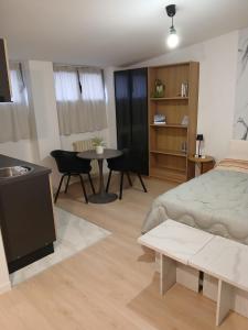 a bedroom with a bed and a table and chairs at Bovisa home in Milan
