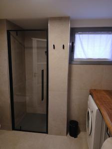a shower with a glass door in a bathroom at Bovisa home in Milan