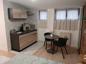 a small kitchen with a table and a microwave at Bovisa home in Milan