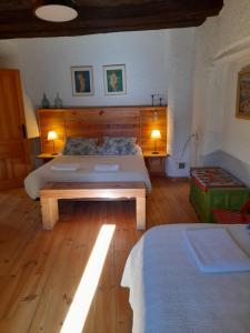 a bedroom with two beds and two tables and two lamps at Casa-Huerto La Juana in Trevélez