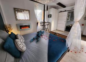 a bedroom with a bed with red flowers on it at A l'Orée des pins - Gite et spa de 30 m2- Options Home Cinéma, Romantique in Cuges-les-Pins