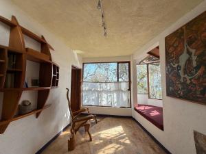 a room with a chair in front of a window at El encinal in San Miguel +140 photos