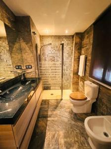 a bathroom with a sink and a toilet and a shower at Sevilla Family House - La casa de Marta in Montequinto