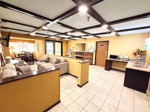 a large living room with couches and a kitchen at Fairview Inn & Suites Whitewater in Whitewater