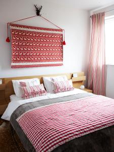 a bedroom with a bed with a red and white blanket at Villa Dorota in Zakopane