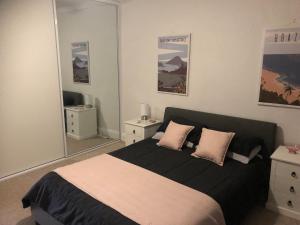 a bedroom with a large bed with two pillows at StevieNic's Dig's in Broken Hill