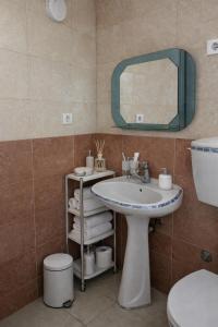 a bathroom with a sink and a toilet and a mirror at Belmare in Ulcinj +23 photos