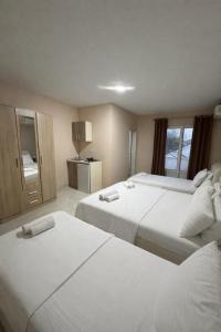 a hotel room with two beds and a window at Belmare in Ulcinj