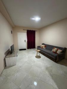 a living room with a couch and a television at Belmare in Ulcinj
