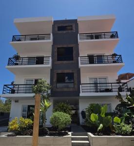 a building with balconies and trees in front of it at Casa Galapagos in Puerto Ayora