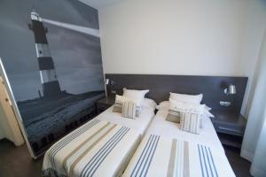 Un ou plusieurs lits dans un hébergement de l'établissement Hostal Cabo Mayor