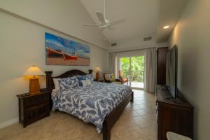 a bedroom with a bed and a flat screen tv at Veranda 4B 3 bdr Golf Course View in Los Suenos in Herradura +43 photos