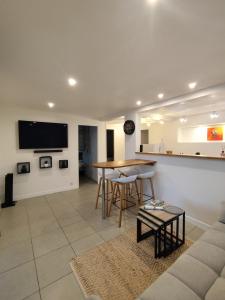 a living room with a table and a couch at Swisstropiclodges avec piscine privée in Sainte-Anne