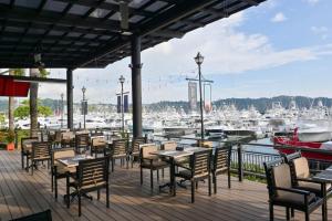 a patio with tables and chairs and a marina at Del Mar 3C 3 bdr Ocean View in Los Suenos in Herradura