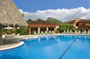 a swimming pool in front of a resort at Colina 5E 2 bdr Garden View in Los Suenos in Jacó