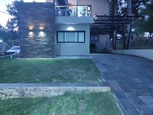 a house with a stone wall and a patio at Apart La Empedrada in Trapiche