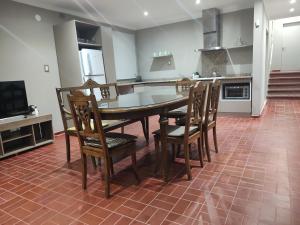 a kitchen with a table and chairs in a kitchen at Apart La Empedrada in Trapiche