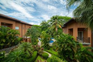 an apartment complex with a courtyard with a swimming pool at Veranda 3B 2 bdr Garden View in Los Suenos in Herradura