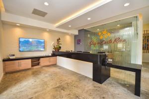a lobby with a reception desk and a sign on the wall at Veranda 3B 2 bdr Garden View in Los Suenos in Herradura +40 photos