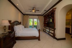 a bedroom with a bed and a dresser and a television at Bella Vista 3F 3 bdr beach club view in Los Suenos in Herradura +44 photos