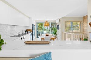 a kitchen with a white counter top and a table at 2-Bed Townhouse with Outdoor Area in Long Beach