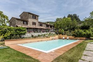 a swimming pool in the yard of a house at Casolare Santa Margherita in Assisi