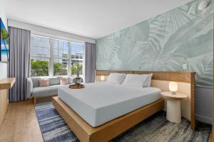 a bedroom with a large white bed and a couch at Park Central South Beach in Miami Beach +136 photos