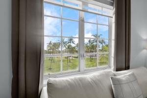 a white couch sitting in front of a large window at Park Central South Beach in Miami Beach