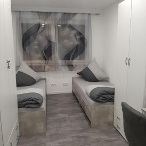 a room with two twin beds in a room at Five Rooms in Sinsheim