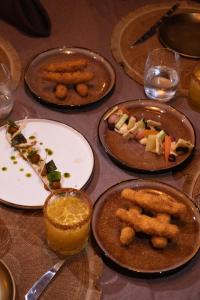 a table with plates of food on it at Gorée Suites in Saly Portudal