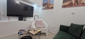 a living room with a couch and a flat screen tv at Cantinho D` Alice in Armamar