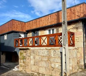 a wooden bridge on the side of a building at Cantinho D` Alice in Armamar