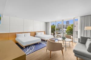 a living room with a couch and a table at Park Central South Beach in Miami Beach