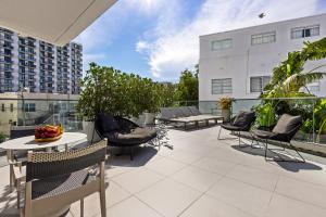 an outdoor patio with chairs and tables on a building at Park Central South Beach in Miami Beach