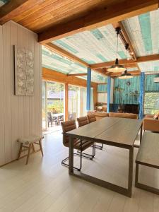 a dining room with a table and chairs at Aqua Beach House Sotoura - 1min walk to Sotoura Beach! in Shimoda