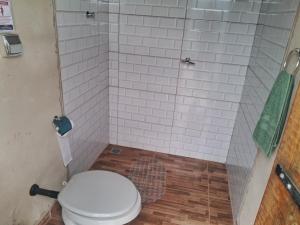 a bathroom with a toilet and a shower at Camping caminho das pedras in São Bento do Sapucaí +52 photos
