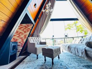 a living room with a couch and a fireplace at Romantic nature retreat | Hot tub and fireplace in São Pedro de Alcântara