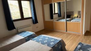 a bedroom with two beds and a mirror at Casa Rural Caraca in Driebes +31 photos