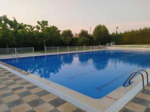a large blue swimming pool with a checkered floor at Casa Rural Caraca in Driebes