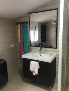 a bathroom with a sink and a large mirror at Enjoy Sevilla in La Rinconada +11 photos