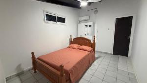 a bedroom with a bed in a white room at Le lis de Udol in Pointe-à-Pitre
