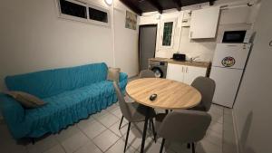 a living room with a blue couch and a table at Le lis de Udol in Pointe-à-Pitre
