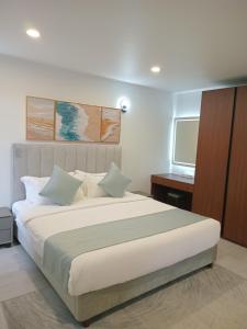 a bedroom with a large bed and a television at Hibiscus Suites And Residences in Nadi +66 photos