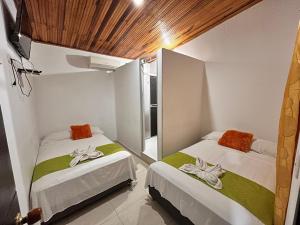 a bedroom with two beds and a window at Casa Hotel Diana Luz in Villavieja