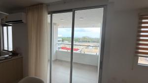 a sliding glass door in a room with a balcony at Cartagena Serena Del Mar INAWA in Cartagena de Indias
