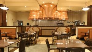 a restaurant with tables and chairs and a kitchen at Blue Lake Casino and Hotel in Blue Lake